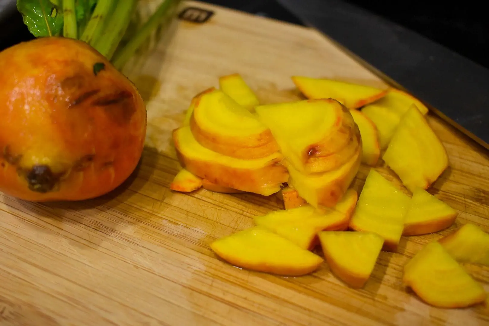 Roasted vegetables - Cats & Coffee Diced golden beets and full golden beet on a cutting board.