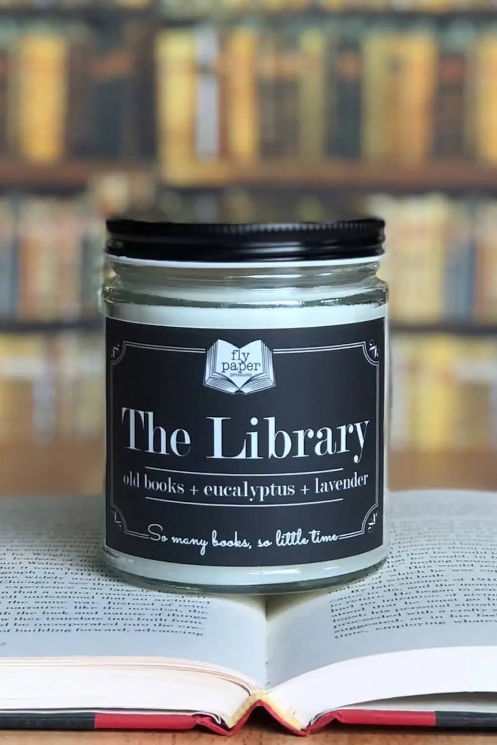 The Best Bookish Candles for Book Lovers 10 Perfect Book and Candle Pairings for a Cozy Reading Night - 9 - Cats & Coffee The Library Candle from Fly Paper Products