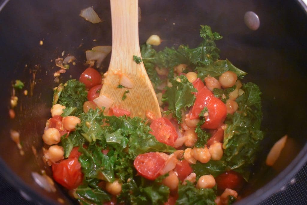 Diced cherry tomatoes, chickpeas, onions, garlic, kale, and olive oil.