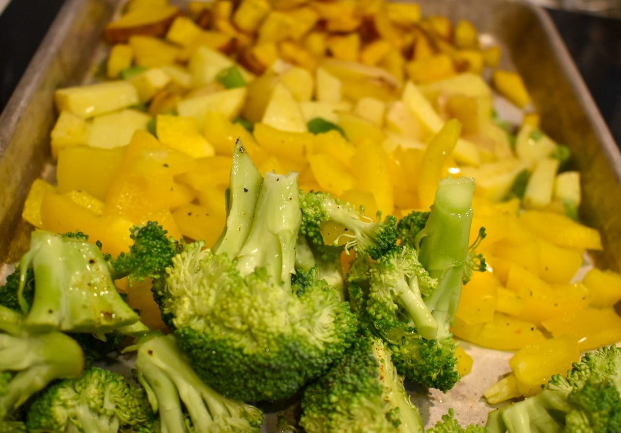 Vegetables diced and tossed in oil and herbs for roasting.