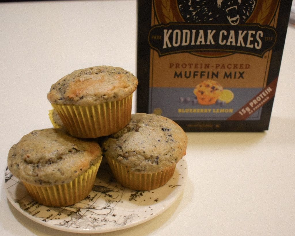Kodiak Cakes Muffin Mix -- blueberry lemon flavor -- with a little Anthropologie plate of freshly baked muffins in yellow wrappers