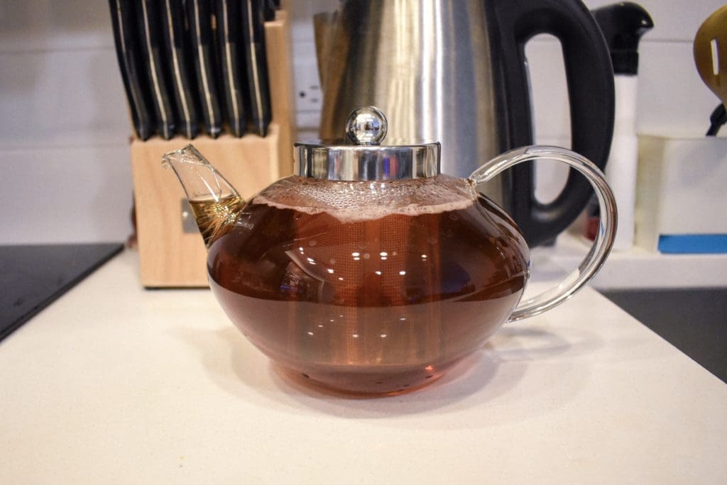 Glass tea pot with black rose tea