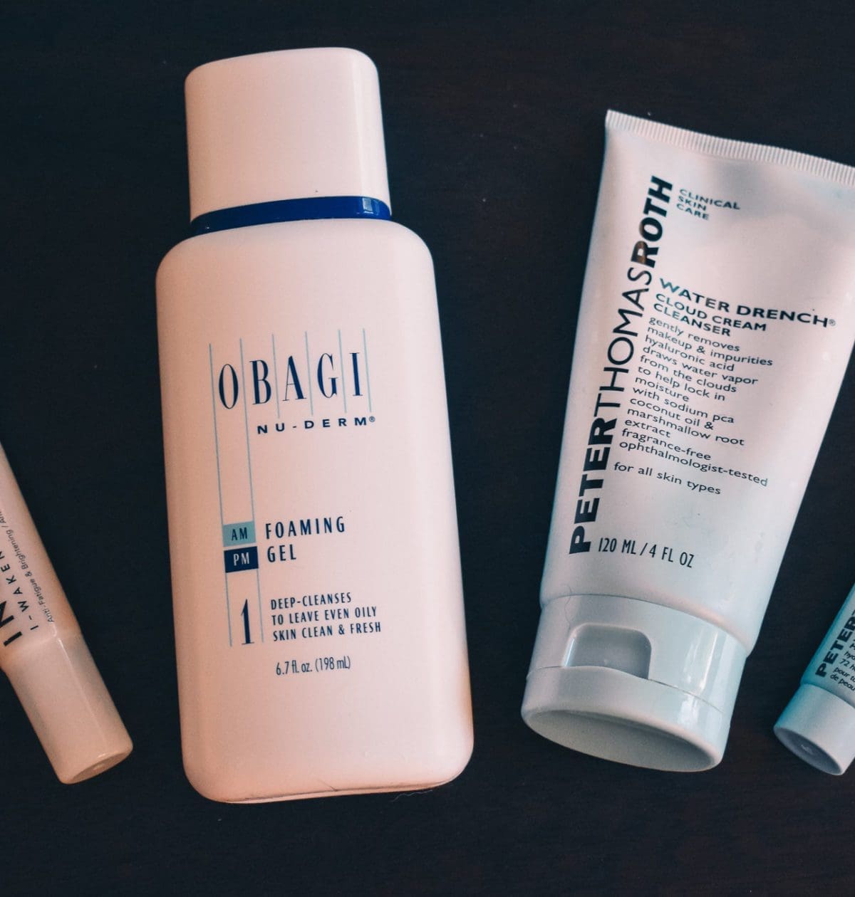 Travel Skincare Essentials, including Obagi Foaming Gel, Peter Thomas Roth Water Drench Cloud Cream Cleanser and Moisturizer, and Indie Lee's I-Waken Eye Serum