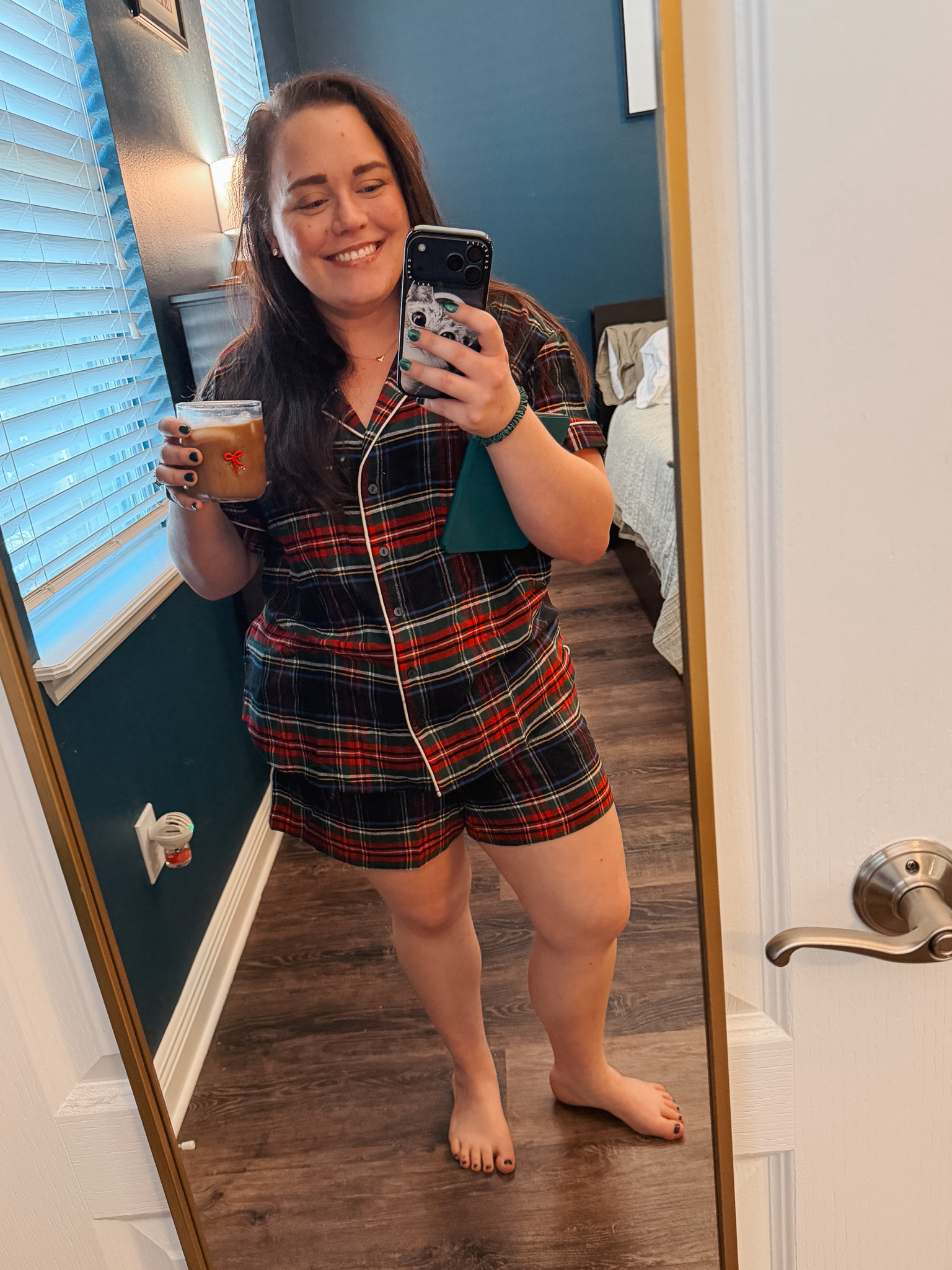 Festive-Tartan-Outfit-Ideas-7-Ways-to-Wear-Tartan-This-Holiday-Season-3webp - Cats & Coffee Woman wearing red and black tartan plaid pajama set with coffee cup — cozy holiday tartan outfit idea for lounging at home